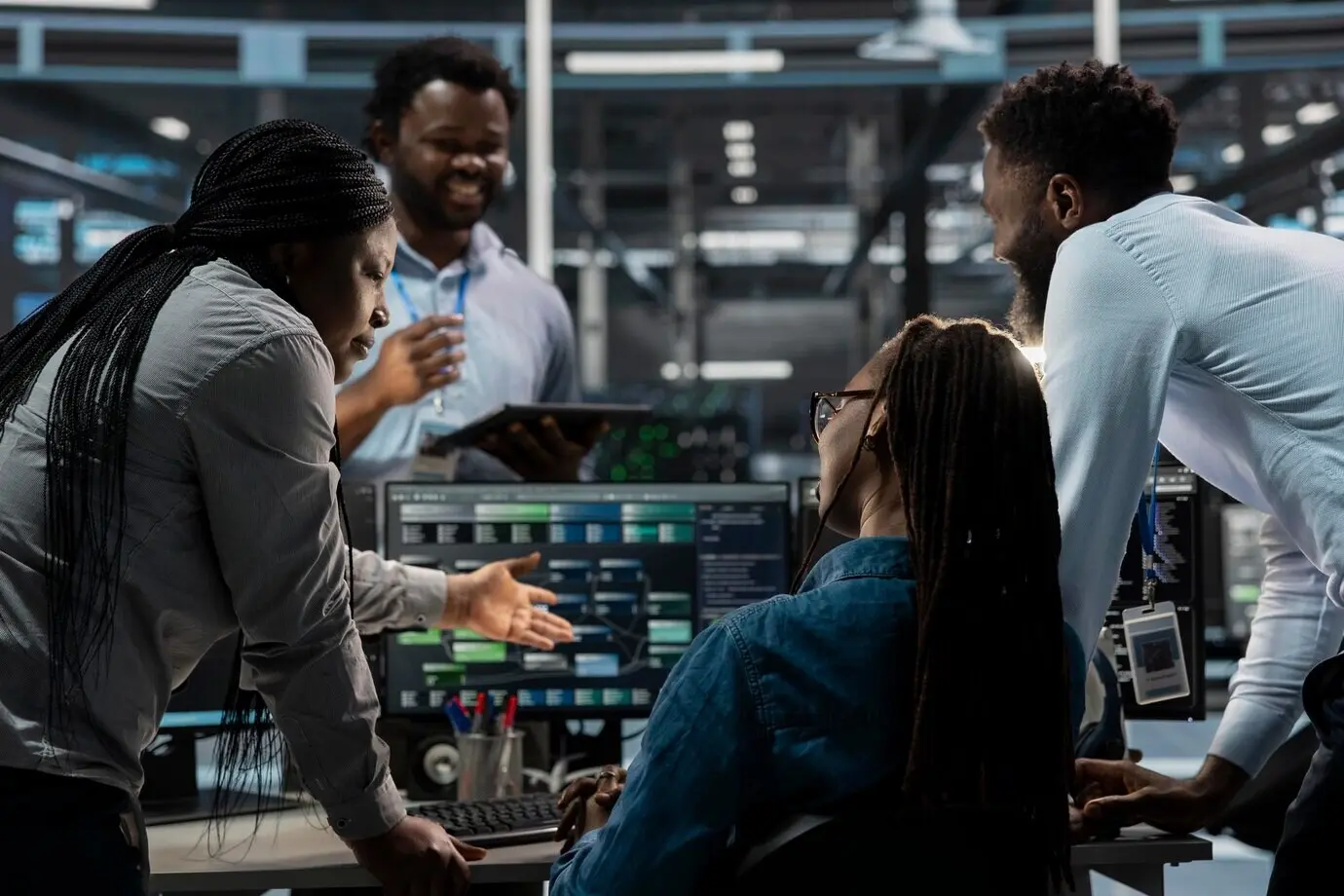 Compañeros de trabajo programando en una granja de servidores que aloja infraestructura avanzada.